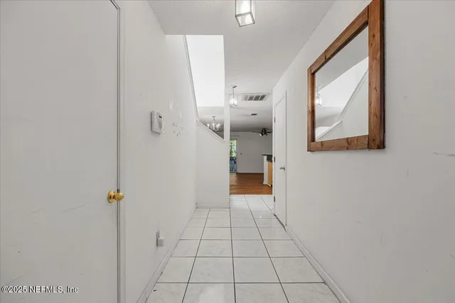 a view of a bathroom from a hallway