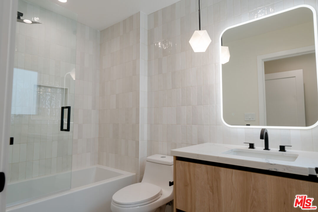 842 North Alfred Street, Unit 1 Los Angeles, CA 90069 - Photo 11 of 14 a bathroom with a sink a toilet and shower
