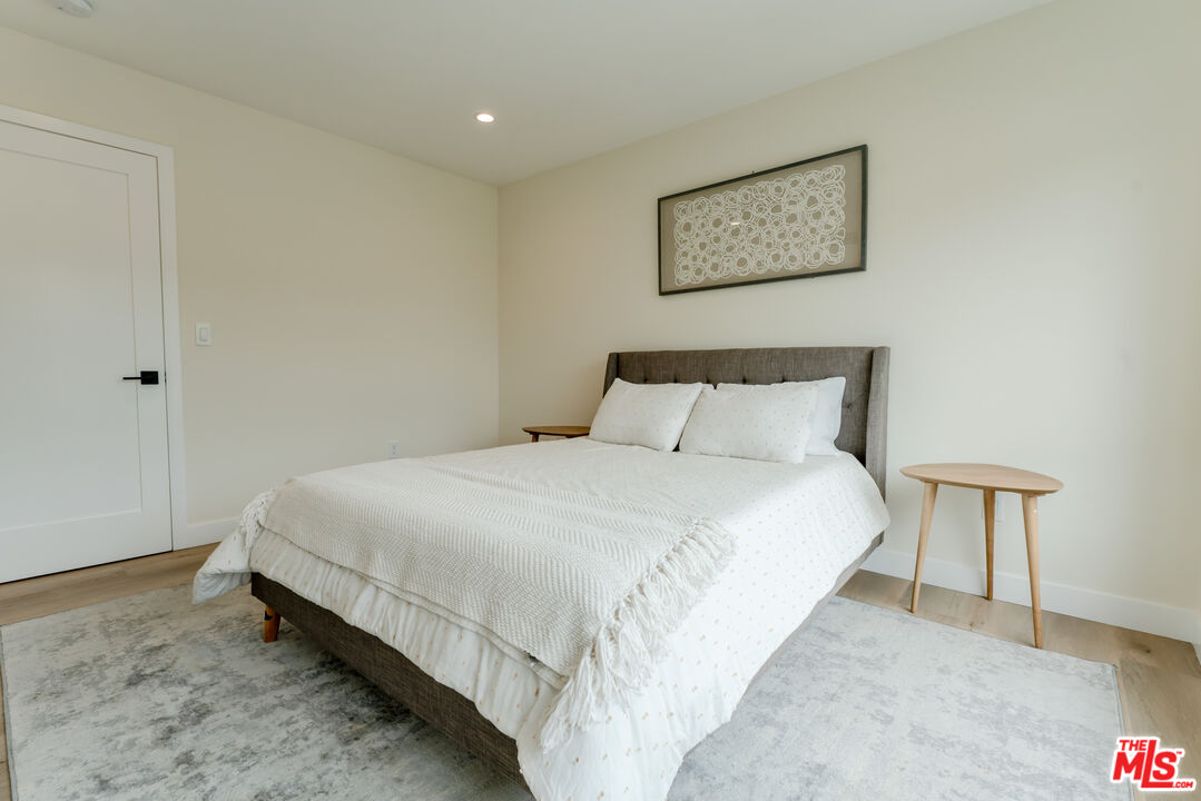 842 North Alfred Street, Unit 1 Los Angeles, CA 90069 - Photo 13 of 14 a bedroom with a bed and a night stand