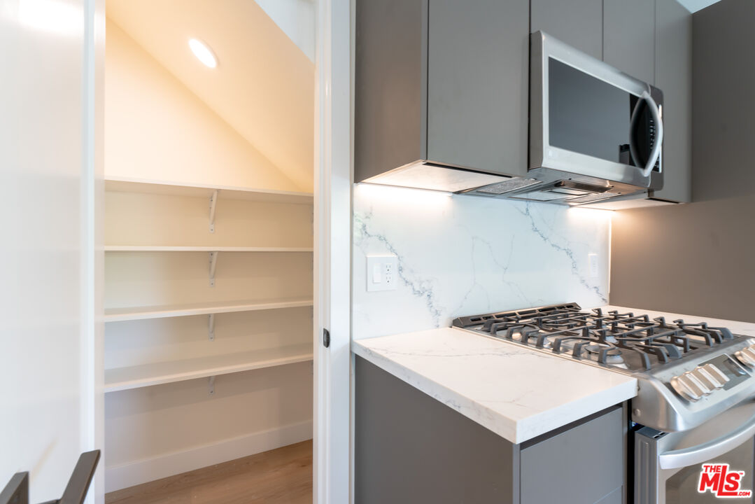 842 North Alfred Street, Unit 1 Los Angeles, CA 90069 - Photo 4 of 14 a kitchen view of a stove and a microwave