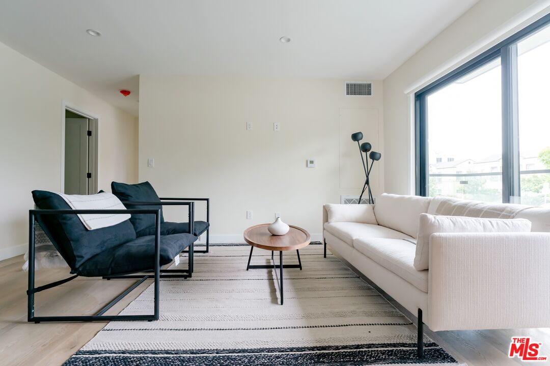 842 North Alfred Street, Unit 1 Los Angeles, CA 90069 - Photo 7 of 14 a living room with furniture and a window