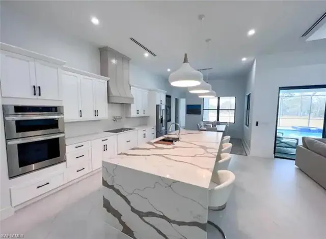a large white kitchen with cabinets