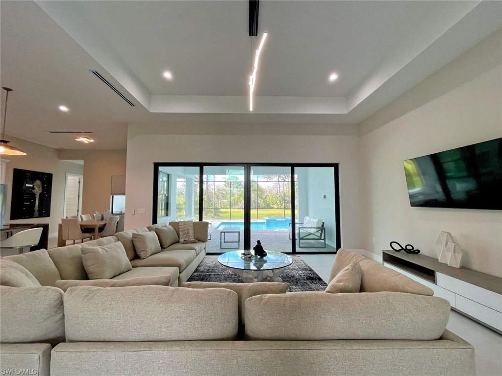 687 23rd Street Southwest Naples, FL 34117 - Photo 33 of 40 Living room with a raised ceiling and recessed lighting