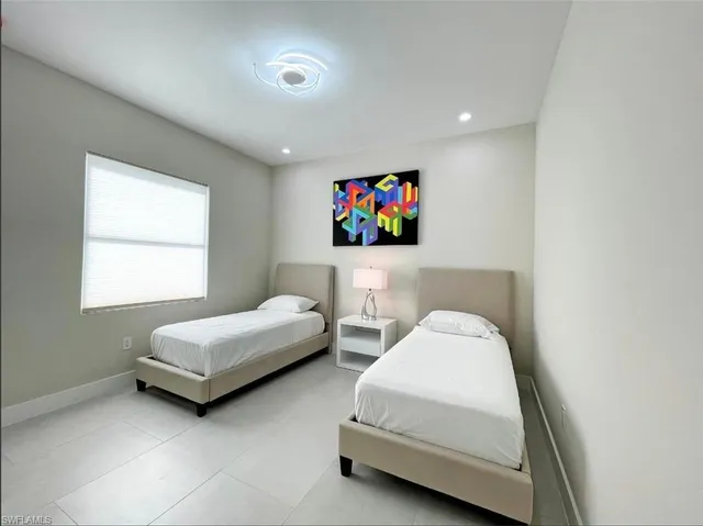 a living room with furniture kitchen view and a large window