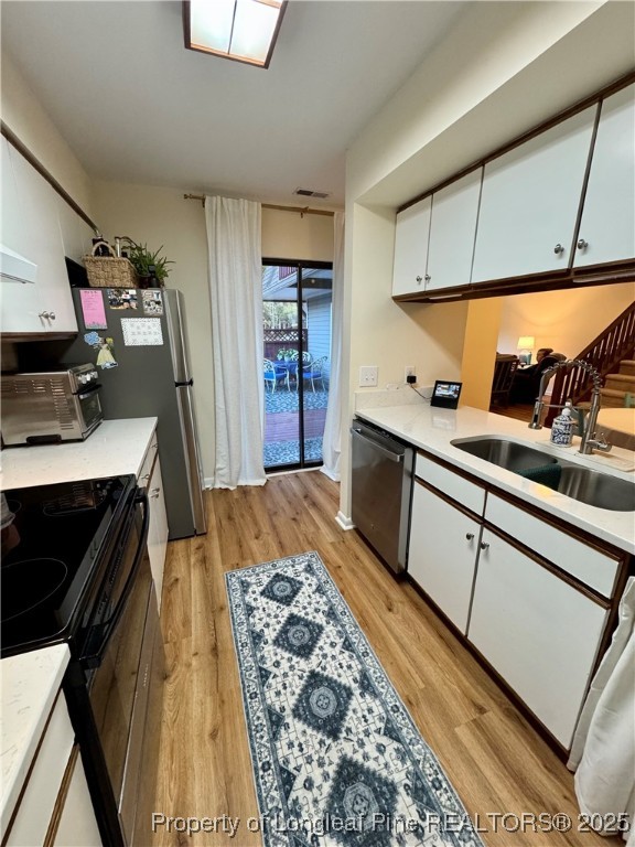 165 Springberry Lane, Unit 165 Chapel Hill, NC 27517 - Photo 11 of 41 a bedroom with a bed and a flat tv screen on the dresser