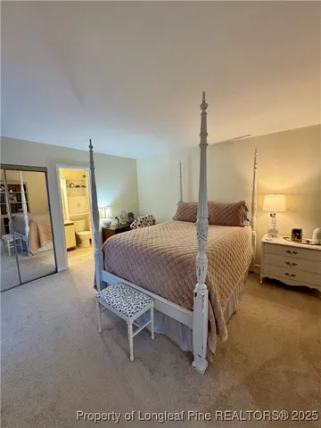 a bedroom with a bed and a mirror