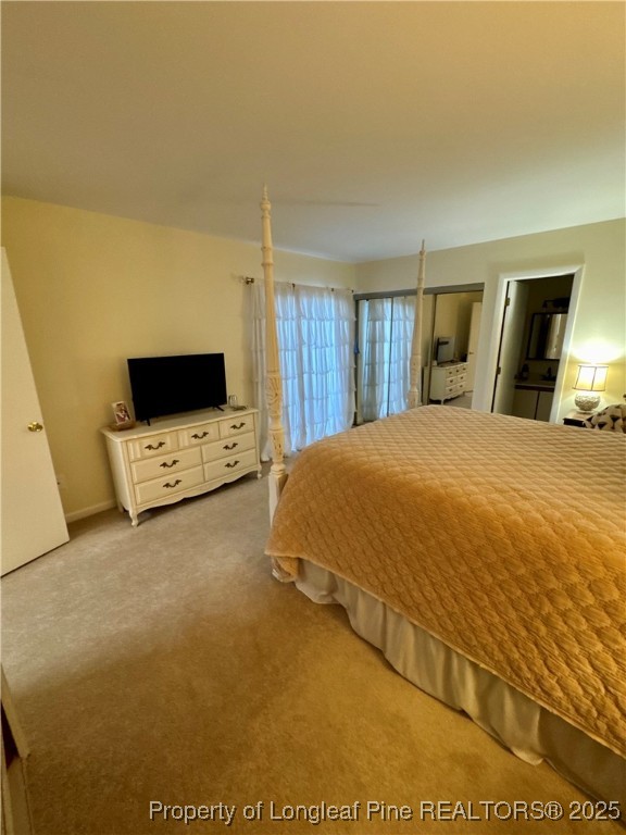 165 Springberry Lane, Unit 165 Chapel Hill, NC 27517 - Photo 23 of 41 a bedroom with a bed a stove and a television