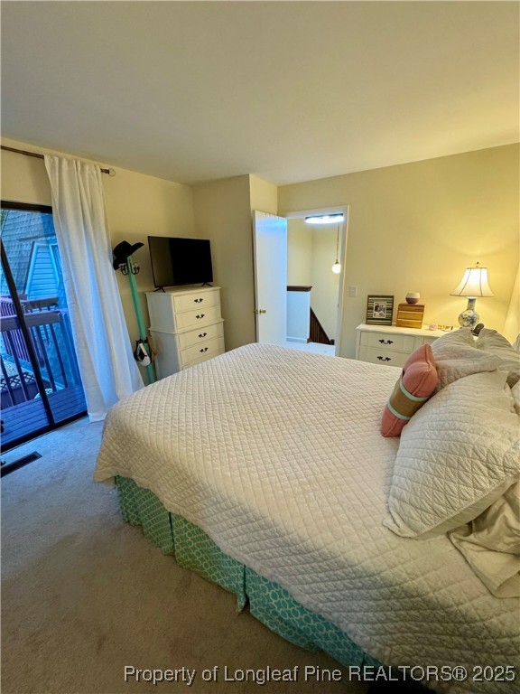 165 Springberry Lane, Unit 165 Chapel Hill, NC 27517 - Photo 28 of 41 a bed sitting in a bedroom and a night stand