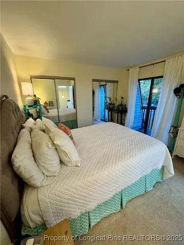 a large bed sitting in a bedroom next to a window