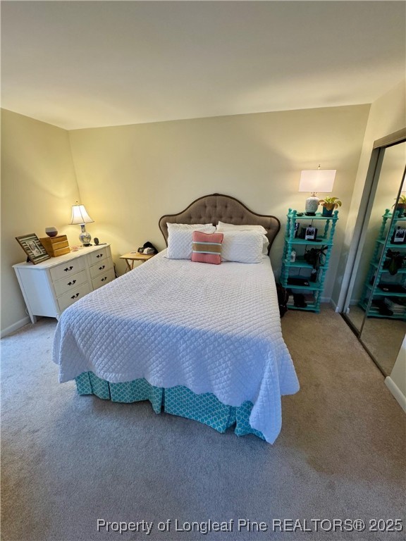 165 Springberry Lane, Unit 165 Chapel Hill, NC 27517 - Photo 30 of 41 a spacious bedroom with a bed and a night stand