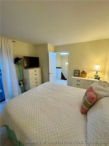 a bed room with a bed and a television