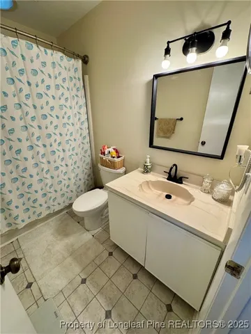 a bathroom with a sink toilet and mirror