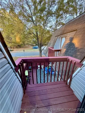 a view of wooden balcony with a bench
