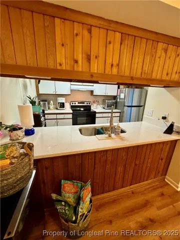 a kitchen with stainless steel appliances kitchen island granite countertop wooden cabinets