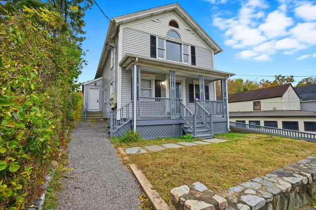 a view of a house with swimming pool next to a yard