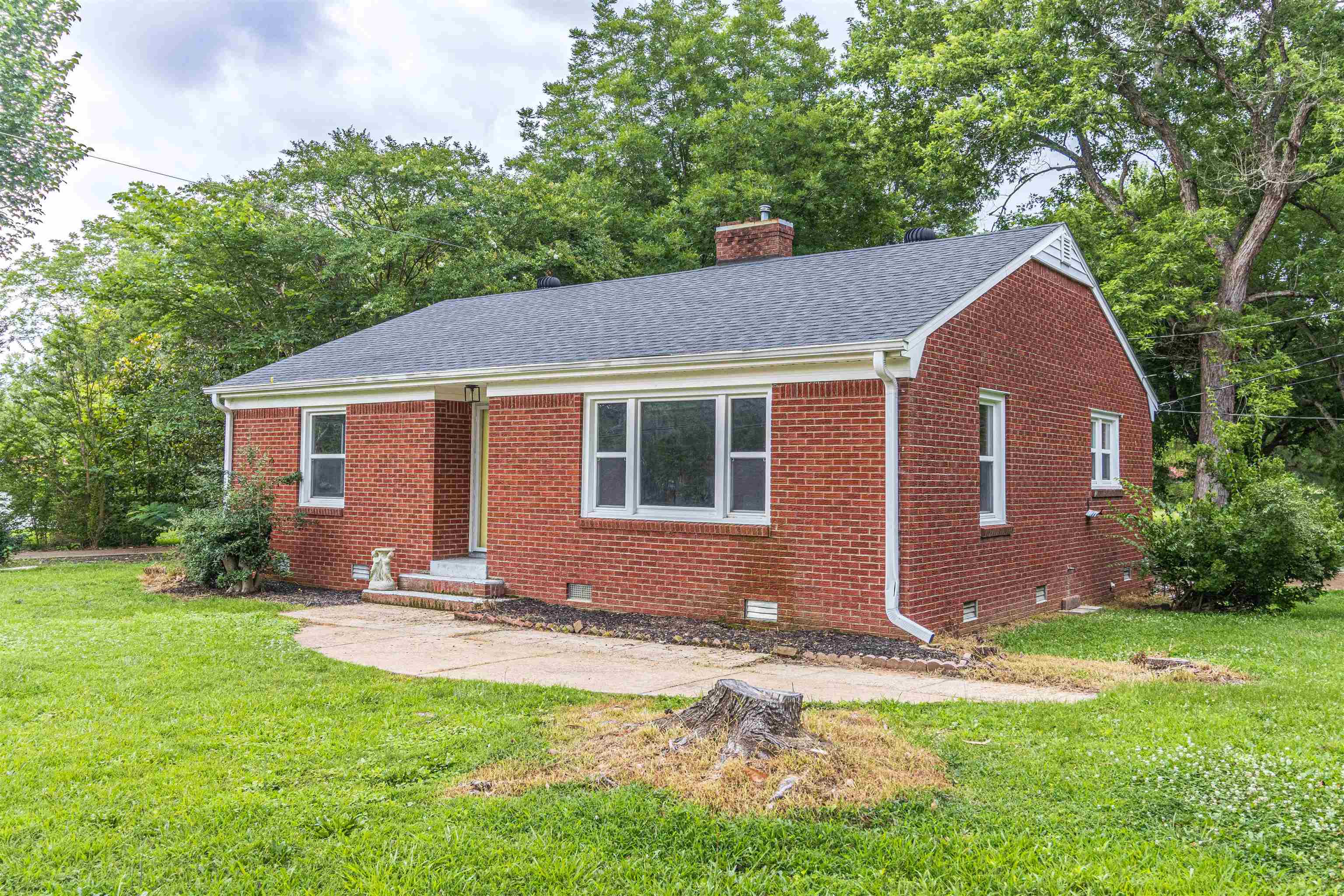 212 North Maple Street Adamsville, TN 38310 - Photo 1 of 25 a front view of house with yard and green space
