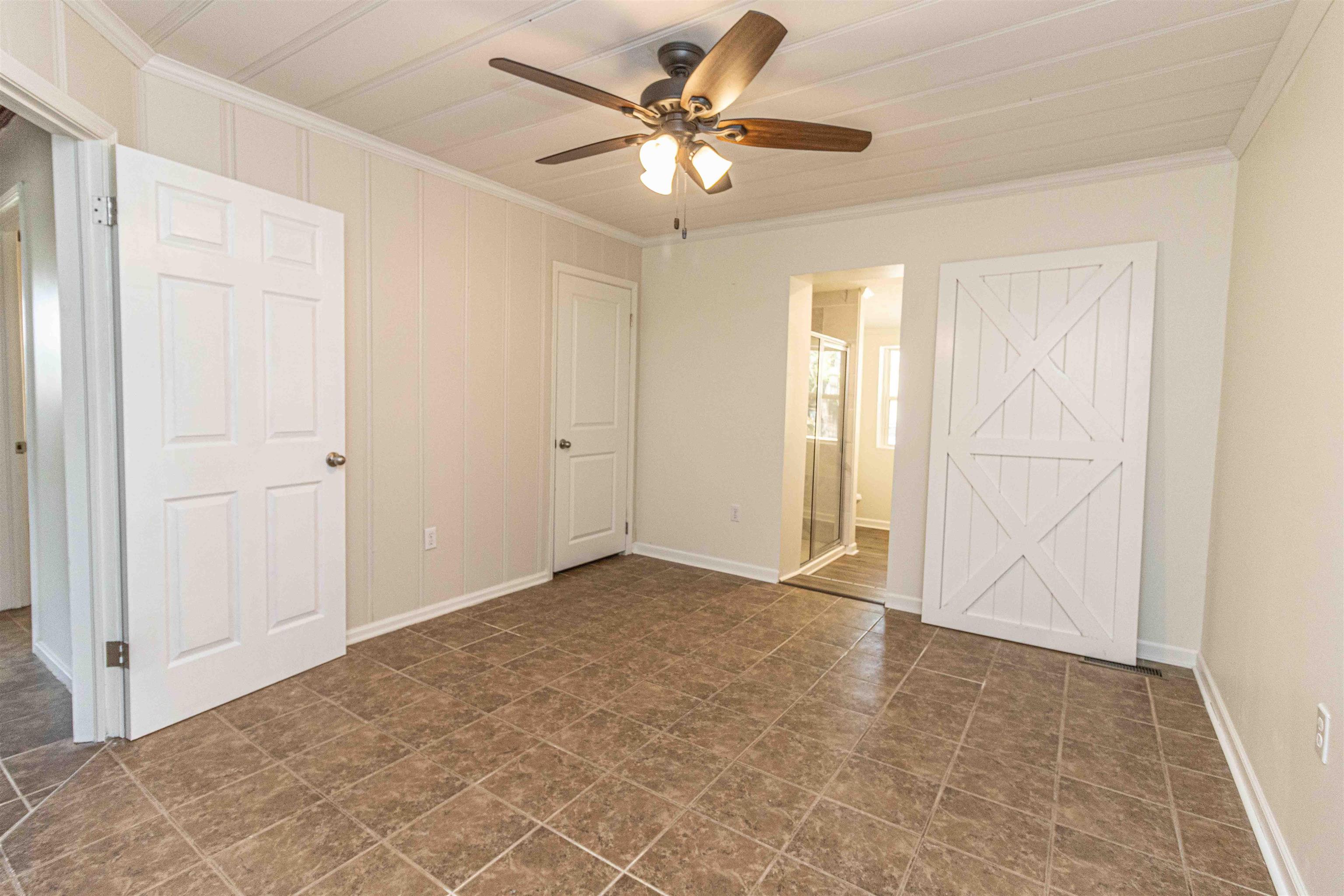 212 North Maple Street Adamsville, TN 38310 - Photo 12 of 25 an empty room with closet and a ceiling fan