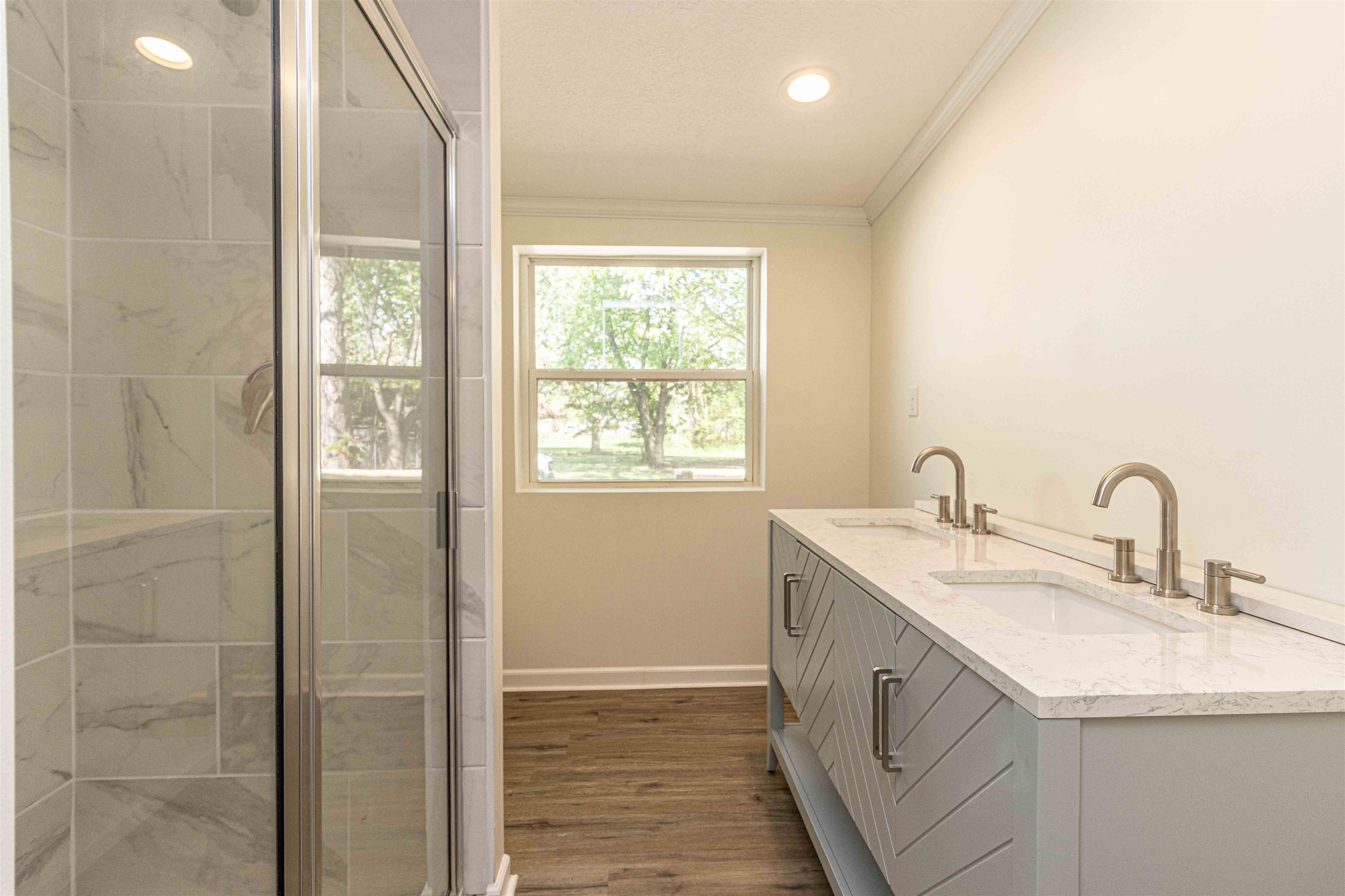 212 North Maple Street Adamsville, TN 38310 - Photo 13 of 25 a bathroom with a double vanity sink and a mirror
