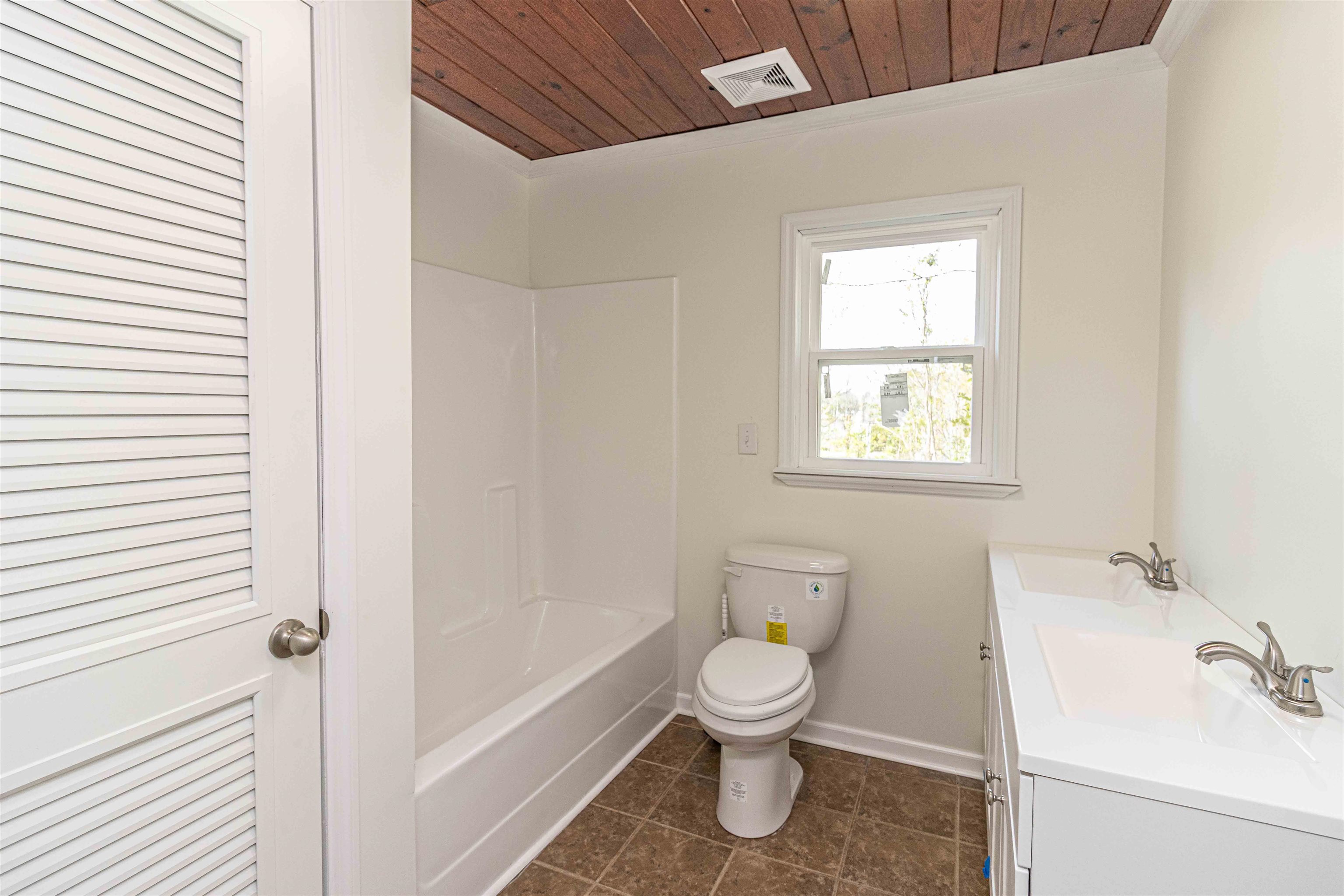 212 North Maple Street Adamsville, TN 38310 - Photo 16 of 25 a white toilet sitting next to a bathroom sink