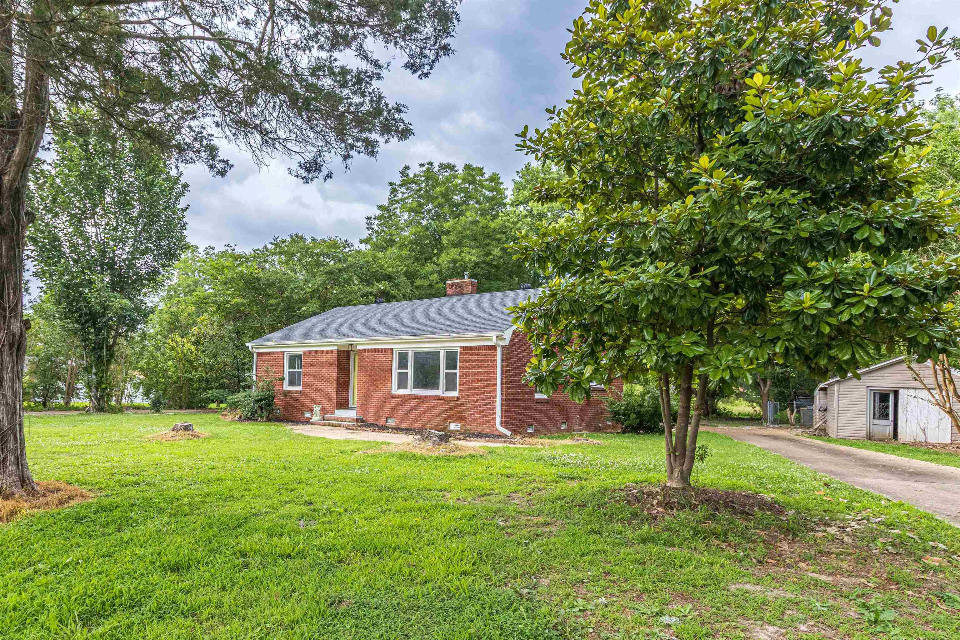 212 North Maple Street Adamsville, TN 38310 - Photo 2 of 25 a front view of a house with garden
