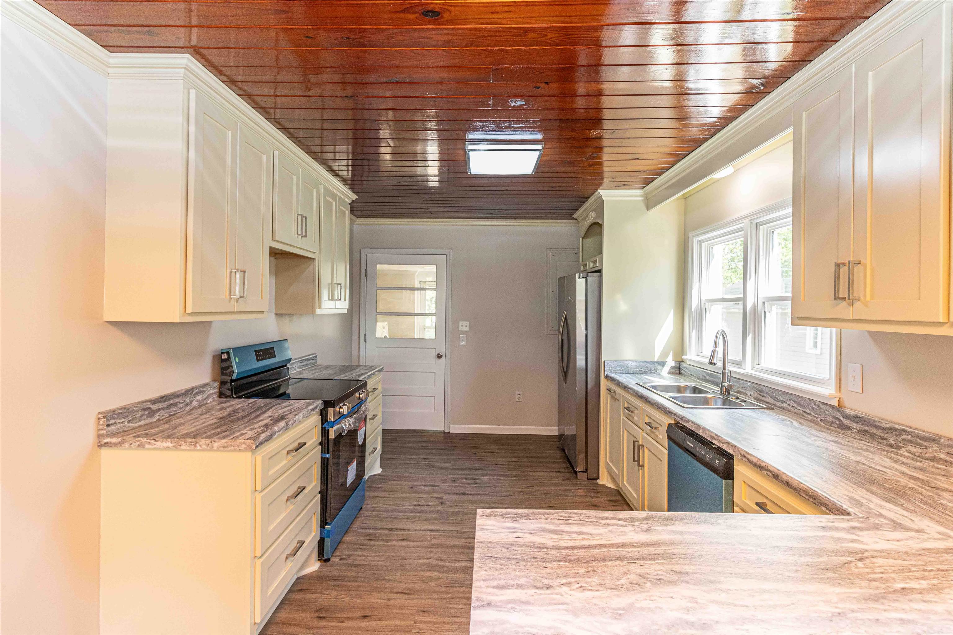 212 North Maple Street Adamsville, TN 38310 - Photo 6 of 25 a kitchen with stainless steel appliances granite countertop a sink stove and cabinets