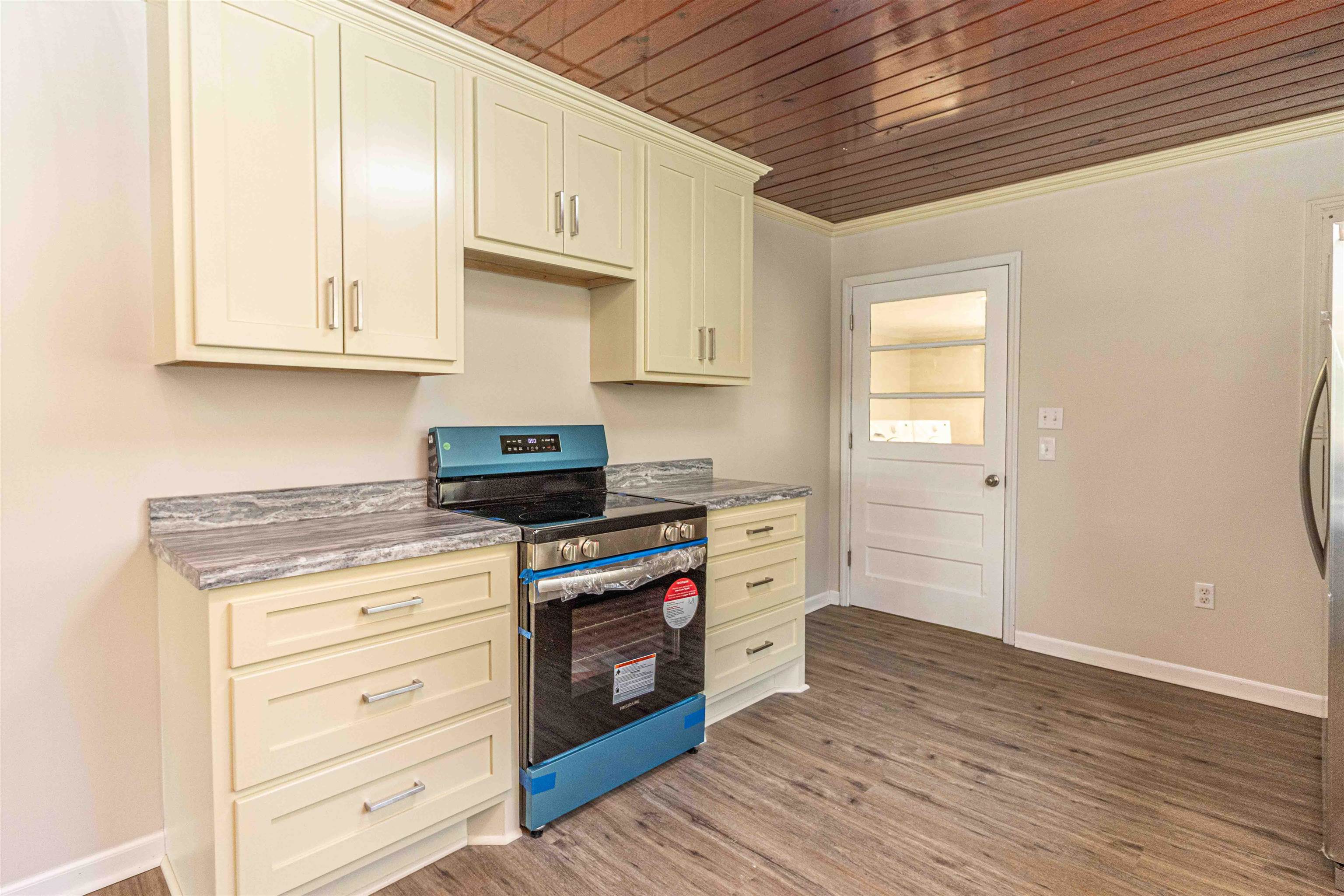 212 North Maple Street Adamsville, TN 38310 - Photo 8 of 25 a kitchen with stainless steel appliances granite countertop a stove and a refrigerator