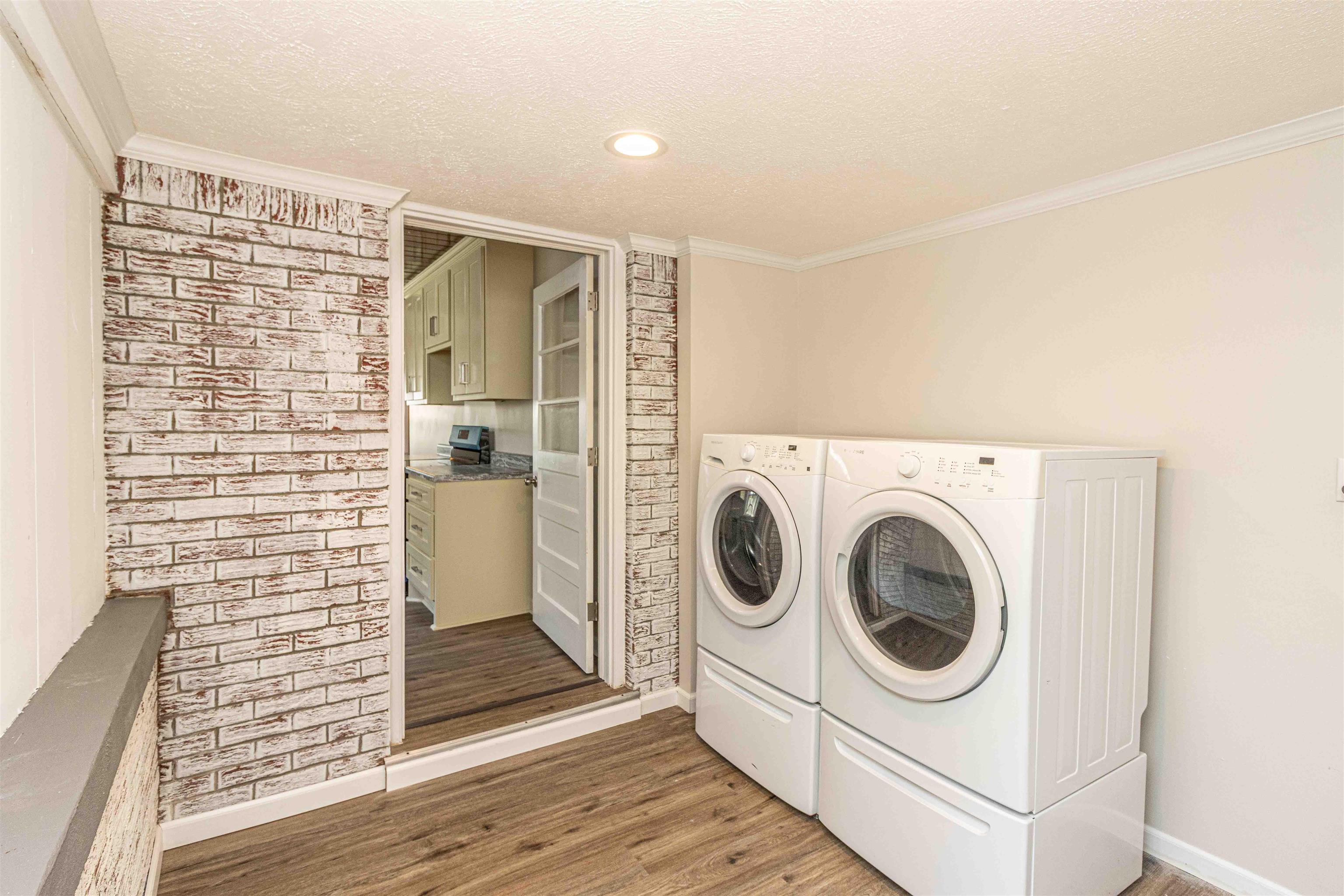 212 North Maple Street Adamsville, TN 38310 - Photo 10 of 25 a view of a hallway with washer and dryer