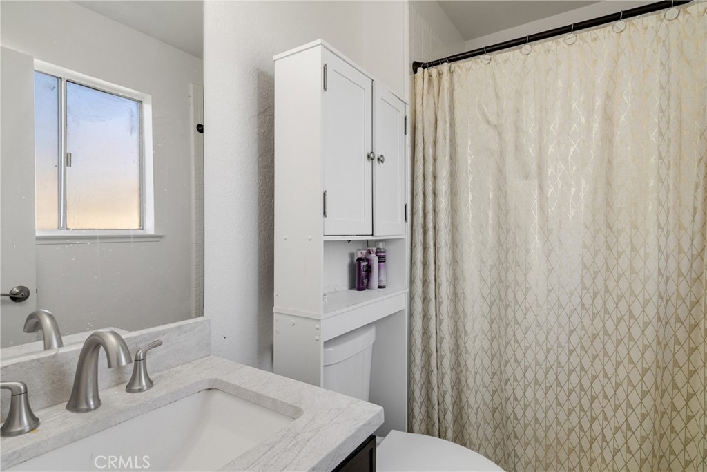 3157 Juneau Court Merced, CA 95348 - Photo 17 of 26 a bathroom with a sink a toilet and shower