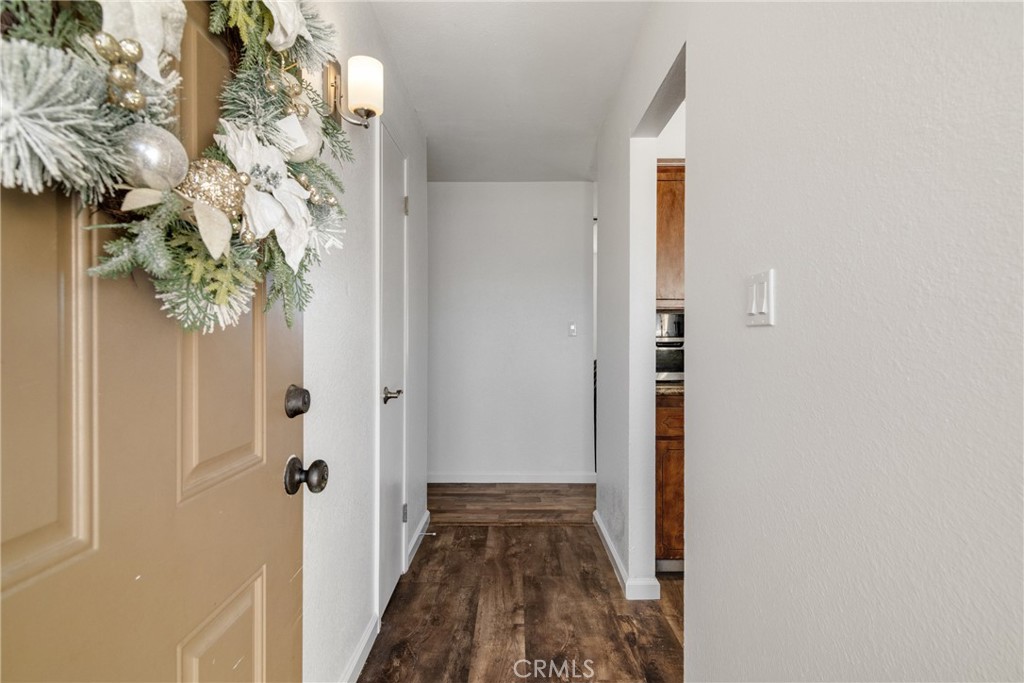 3157 Juneau Court Merced, CA 95348 - Photo 4 of 26 a view of a hallway with wooden floor and front door