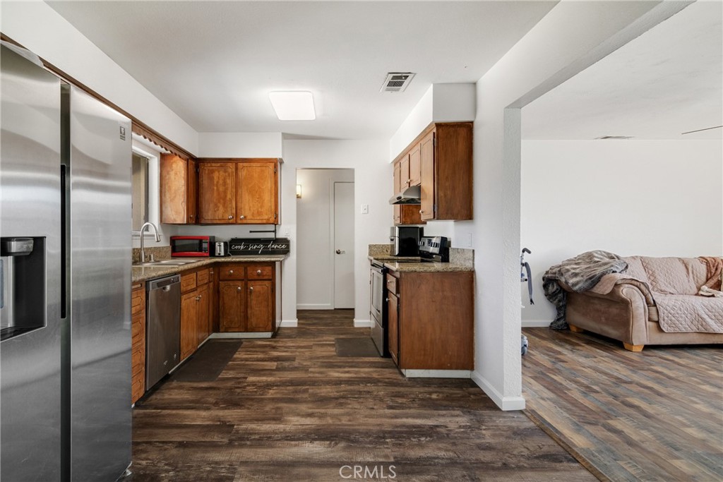 3157 Juneau Court Merced, CA 95348 - Photo 10 of 26 a kitchen with a refrigerator and a sink
