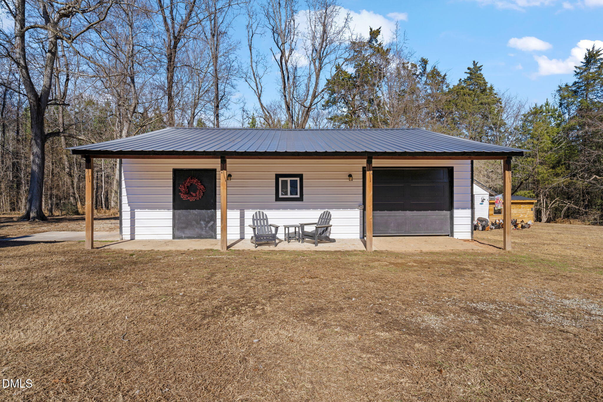 2822 Little River Church Road Hurdle Mills, NC 27541 - Photo 5 of 26 a front view of a house with garden and garage