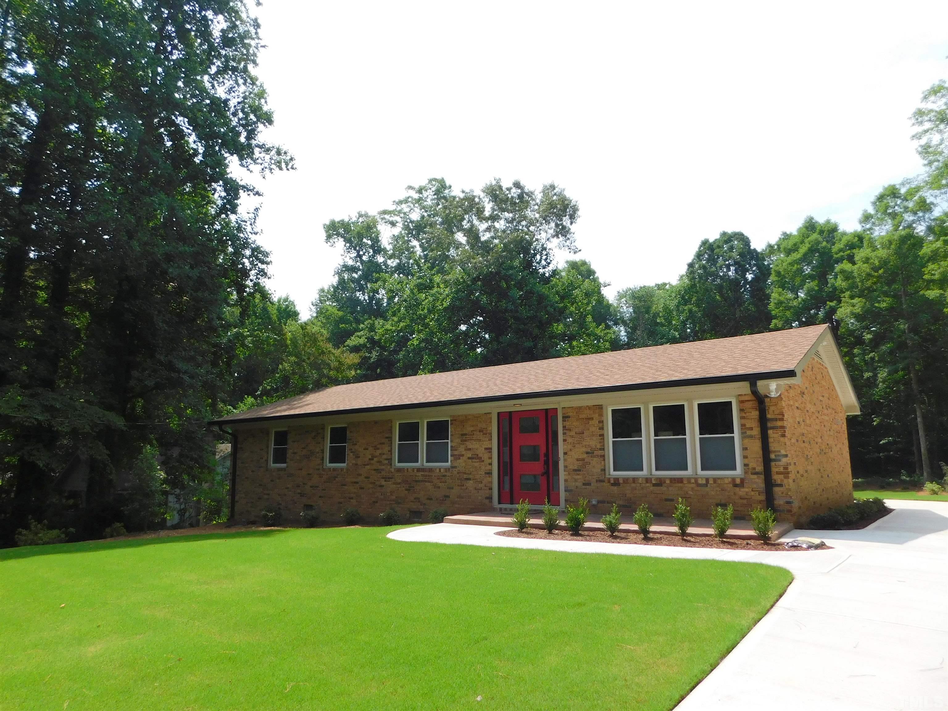 6708 Johnsdale Road Raleigh, NC 27615 - Photo 1 of 44 a front view of a house with a yard
