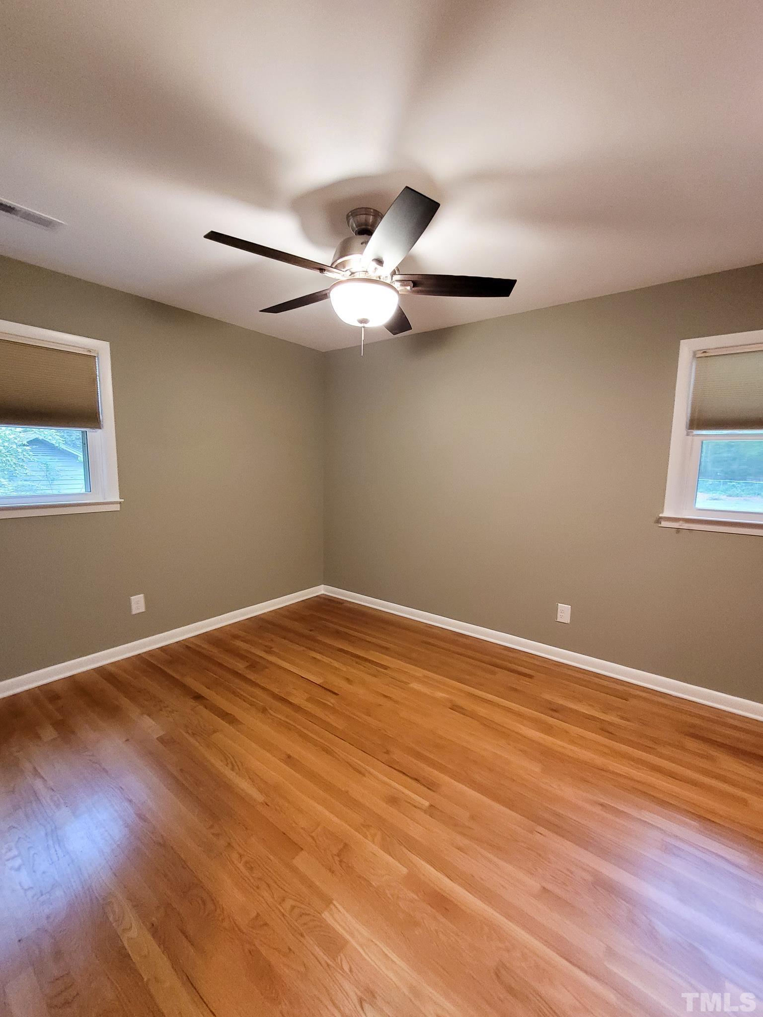 6708 Johnsdale Road Raleigh, NC 27615 - Photo 32 of 44 a view of an empty room with wooden floor
