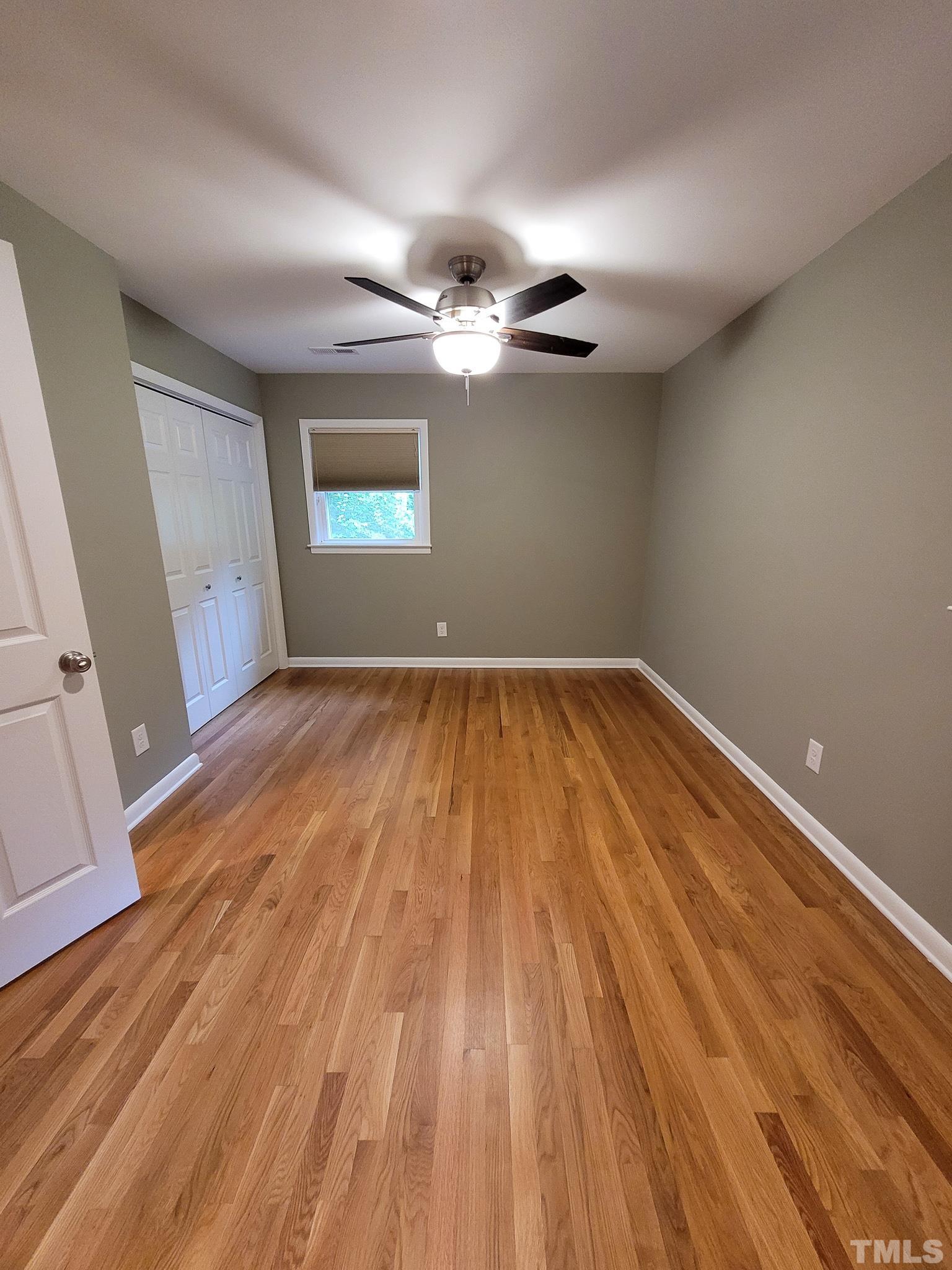 6708 Johnsdale Road Raleigh, NC 27615 - Photo 36 of 44 wooden floor in an empty room with a window