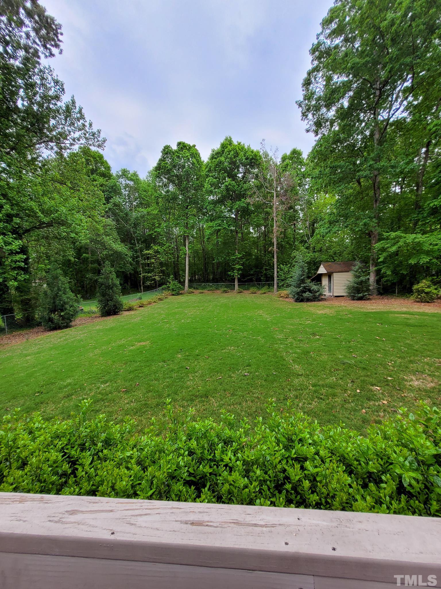 6708 Johnsdale Road Raleigh, NC 27615 - Photo 44 of 44 a backyard of a house with lots of green space