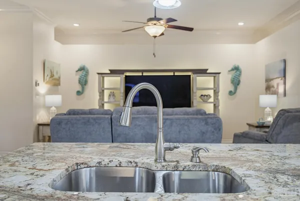 a large kitchen with stainless steel appliances kitchen island granite countertop a sink a stove top oven a counter space and cabinets
