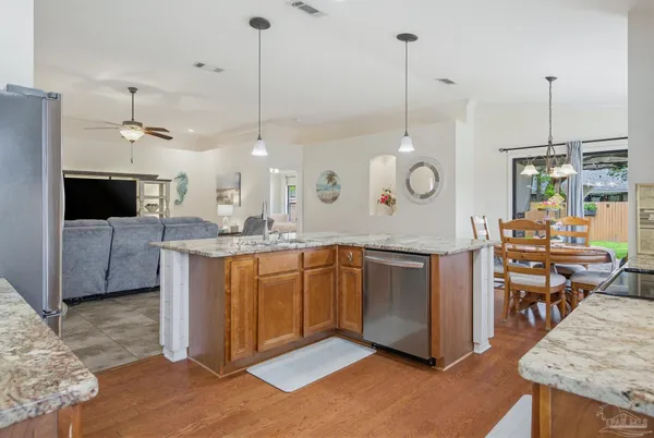 a kitchen with stainless steel appliances granite countertop a refrigerator and a sink