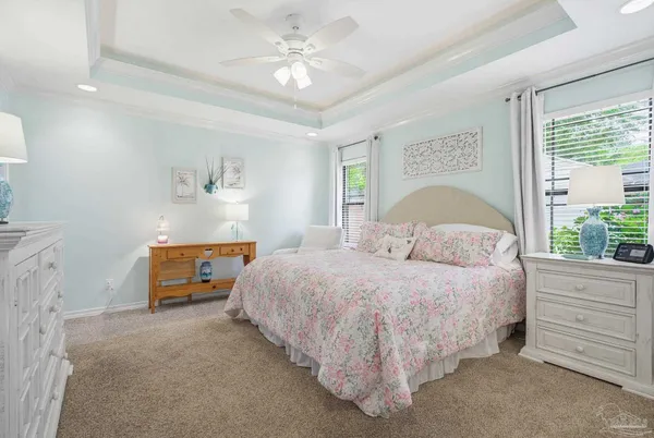 a bedroom with a bed and a flat screen tv in white walls