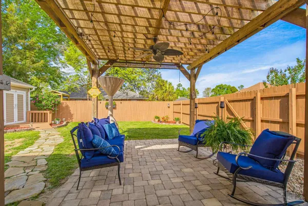 a view of a house with a yard and sitting area