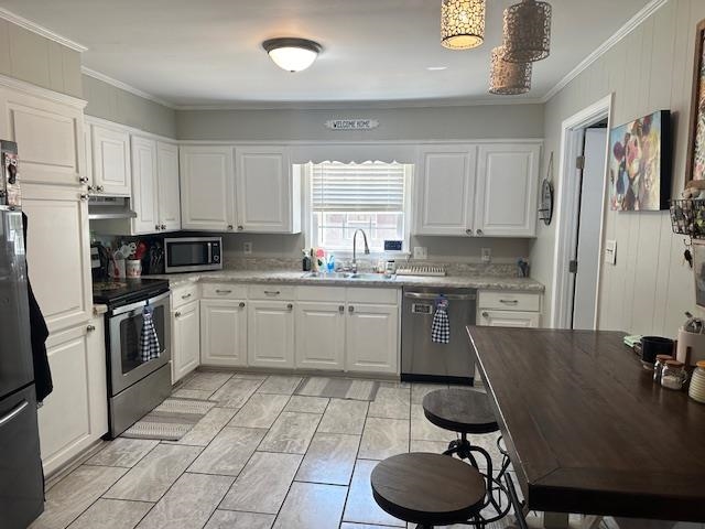 40 Lewter Road Crump, TN 38327 - Photo 2 of 25 Kitchen with ornamental molding, stainless steel appliances, white cabinetry, and sink