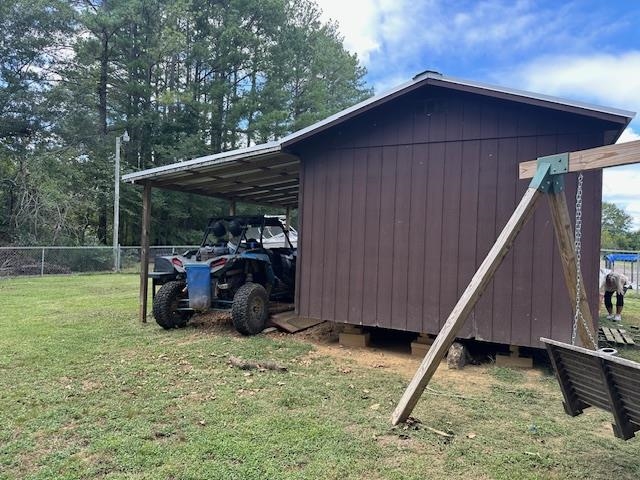 40 Lewter Road Crump, TN 38327 - Photo 22 of 25 View of outbuilding featuring a carport and a yard