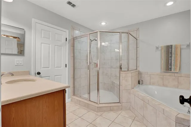 a spacious bathroom with a tub shower and sink