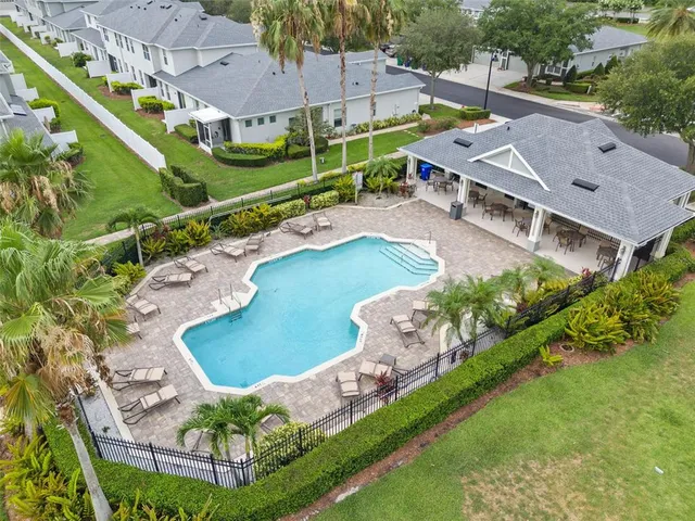 an aerial view of a house with a garden and swimming pool
