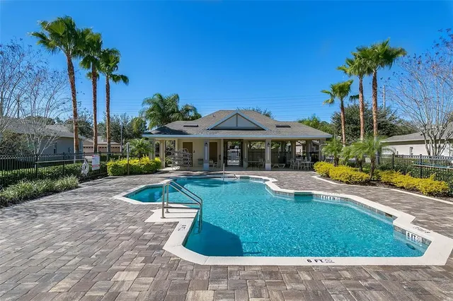 a view of a house with swimming pool and sitting area