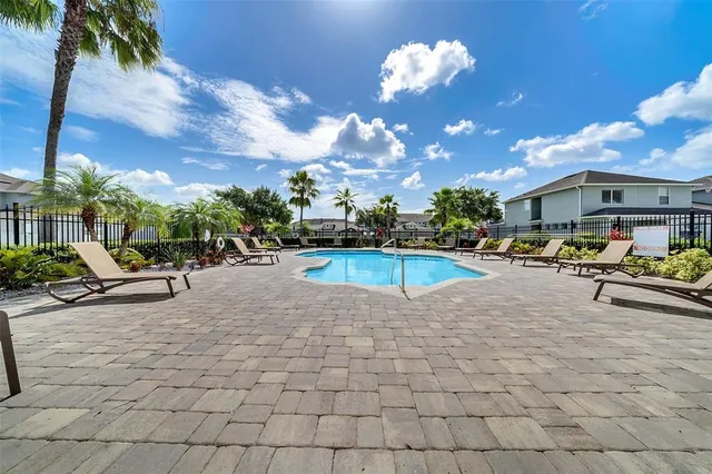 a view of a swimming pool with a patio