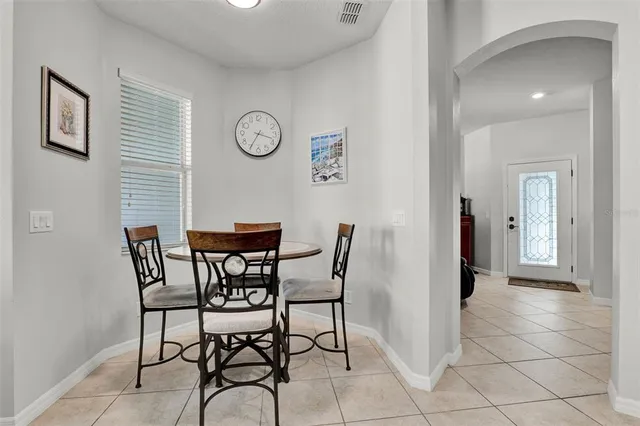 a dining room with furniture and a window