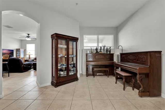 a living room with furniture a piano and a piano