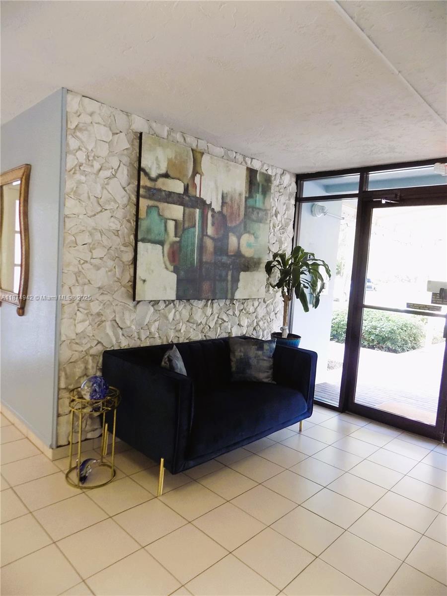 3100 North Course Lane, Unit 502 Pompano Beach, FL 33069 - Photo 12 of 32 a living room with furniture and a fireplace