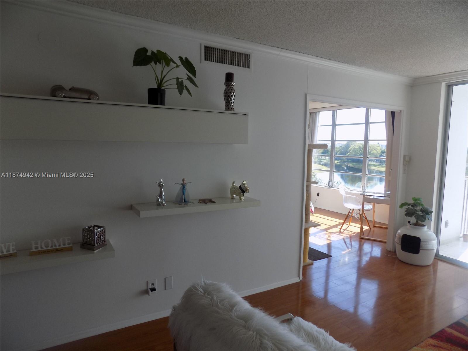 3100 North Course Lane, Unit 502 Pompano Beach, FL 33069 - Photo 17 of 32 a living room with furniture and a floor to ceiling window