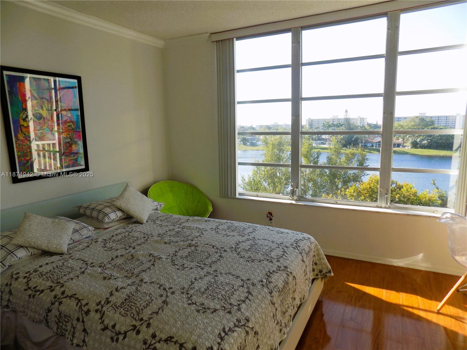 3100 North Course Lane, Unit 502 Pompano Beach, FL 33069 - Photo 19 of 32 a bedroom with a bed and window